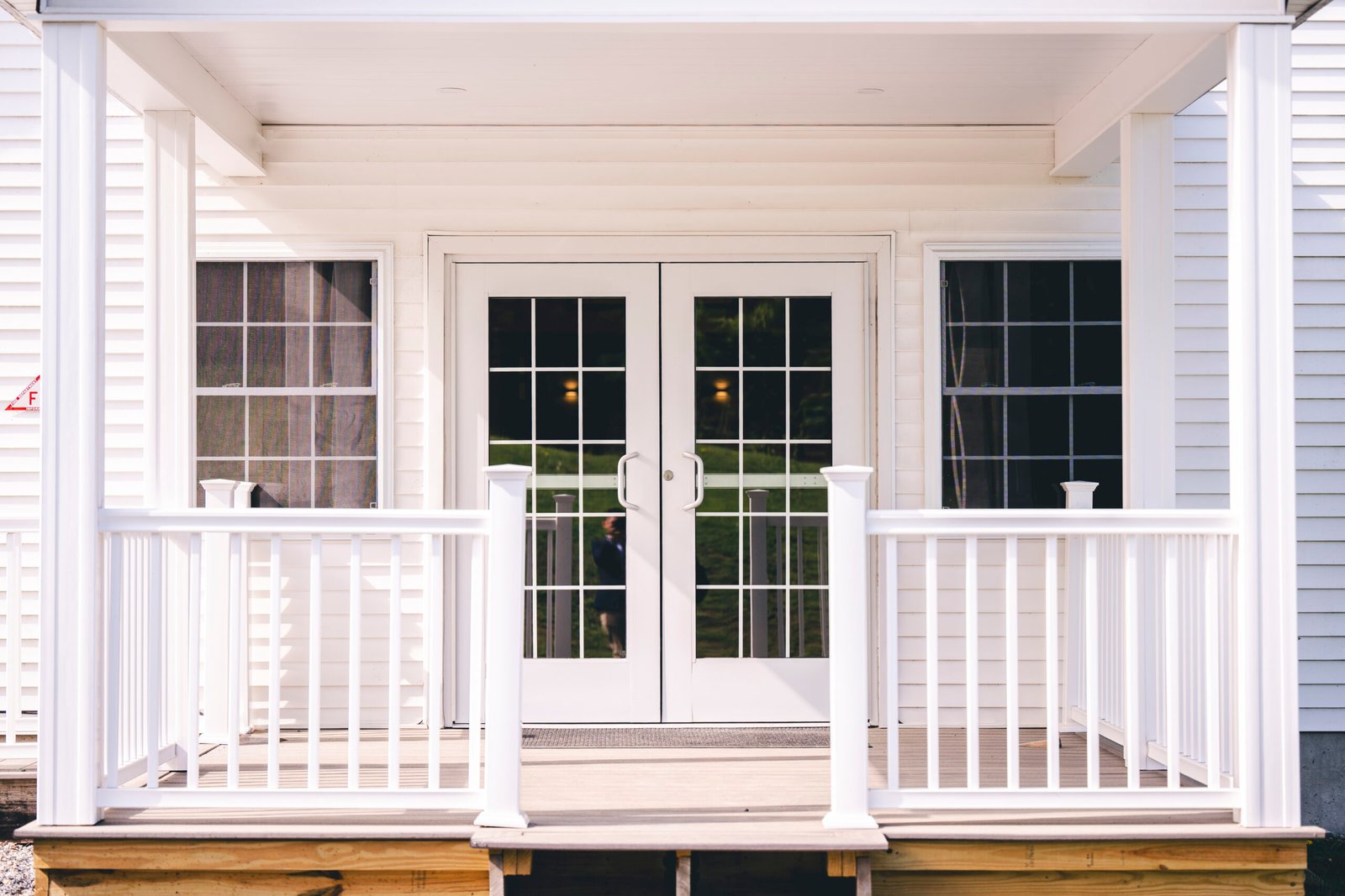 A white house with two windows and doors