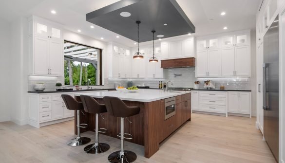 a kitchen with two bar stools next to a marble countertop Modern kitchen with two bar stools by a marble countertop