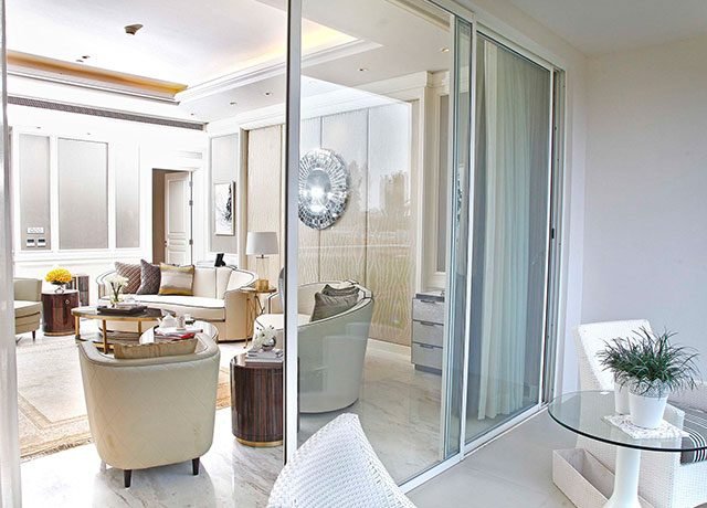 Modern living room with stylish furnishings, floor-to-ceiling windows, and elegant decor, showcasing luxury residential design by Rizo Homes.