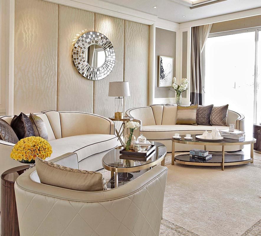 residence_living Spacious and elegantly designed living room featuring modern furniture, decorative pillows, a round mirror, and stylish coffee tables, reflecting Rizo Homes' commitment to quality in residential projects.